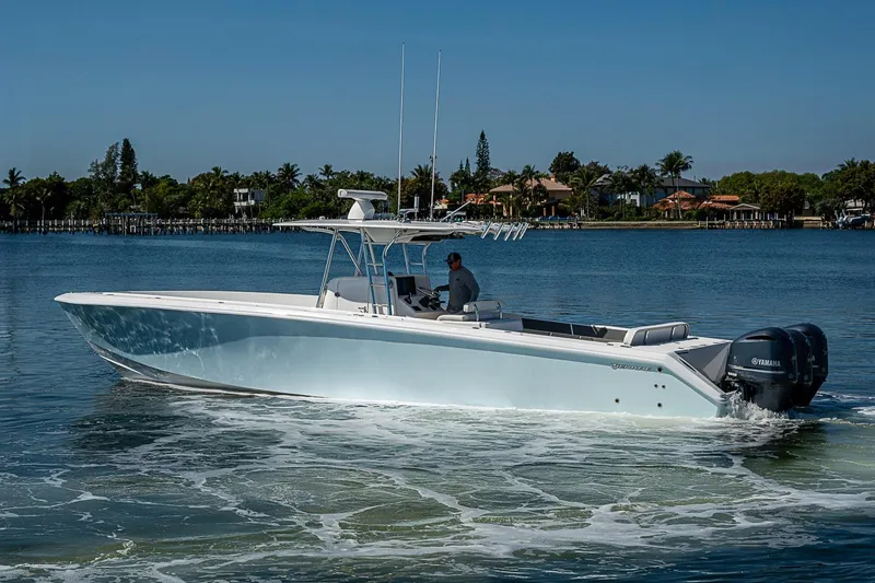 Slide: The Image of 2017 Venture 39 Open boat cruising on calm waters with scenic background. - 19