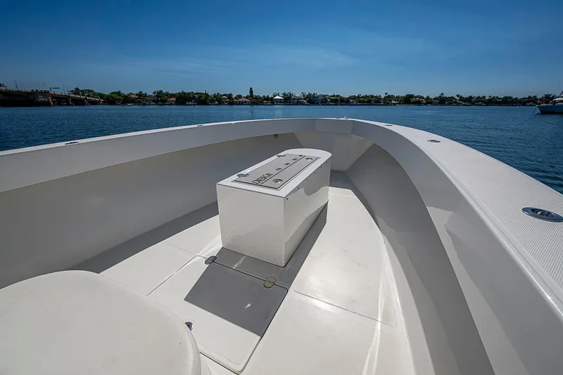 Slide: The Image of 2017 Venture 39 Open boat deck with storage, overlooking calm waters and clear blue sky. - 21