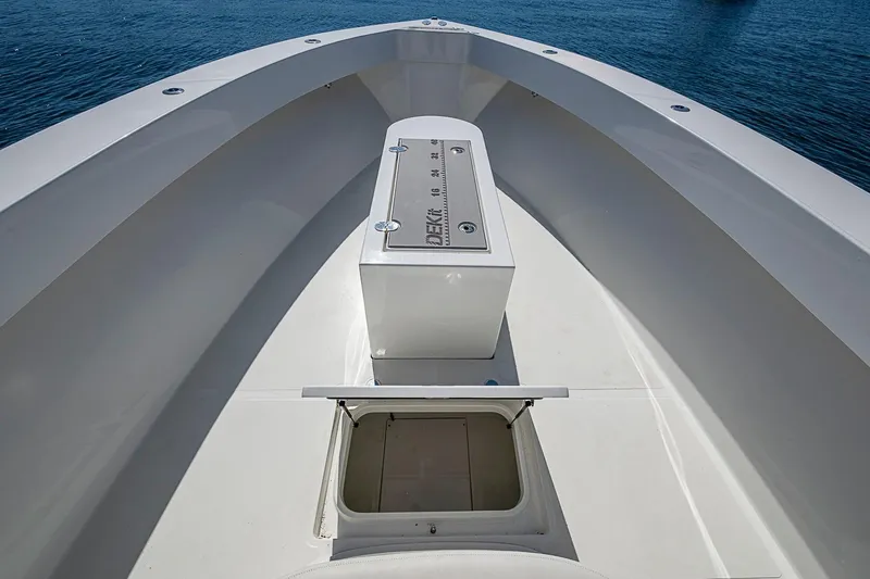 Slide: The Image of 2017 Venture 39 Open boat deck with storage compartments, on calm blue water. - 23