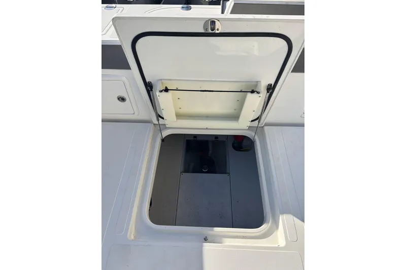 Slide: The Image of Open hatch on 2017 Venture 39 Open boat deck, revealing storage compartment. - 24