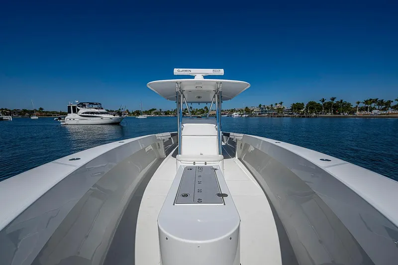 Slide: The Image of 2017 Venture 39 Open boat on calm water, clear blue sky, and distant shoreline. - 27