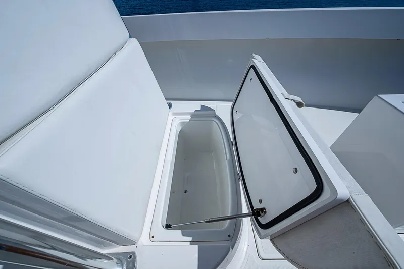 Slide: The Image of Open storage compartment on 2017 Venture 39 Open boat, featuring white cushioned seating. - 30