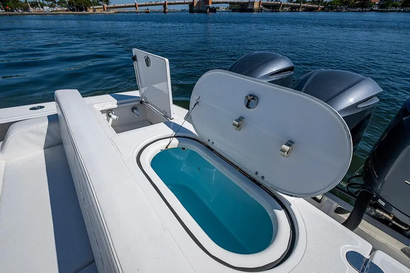 Slide: The Image of 2017 Venture 39 Open boat with open hatch and twin outboard motors on water. - 31