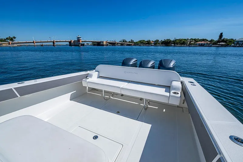 Slide: The Image of 2017 Venture 39 Open boat with triple engines on calm water. - 32