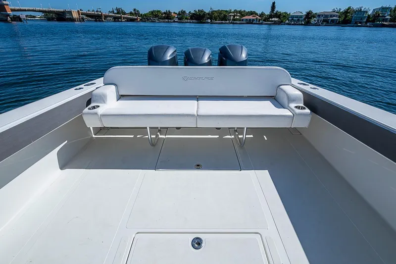 Slide: The Image of 2017 Venture 39 Open boat with spacious deck and seating, overlooking calm waters. - 33