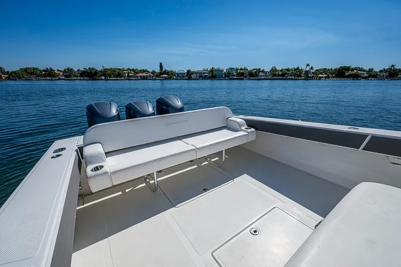 Slide: The Image of 2017 Venture 39 Open boat with triple engines, spacious deck, and scenic waterfront view. - 34