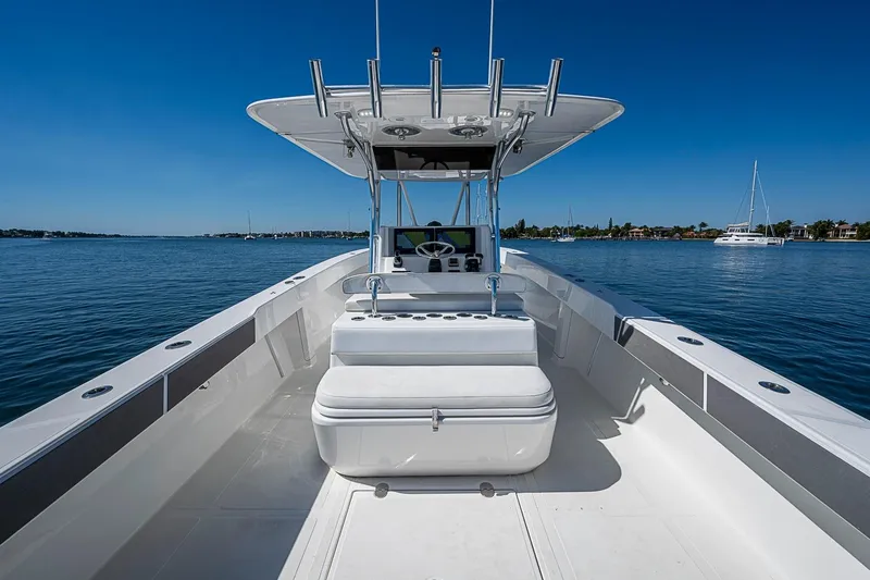 Slide: The Image of 2017 Venture 39 Open boat on calm water, featuring spacious deck and modern helm. - 38