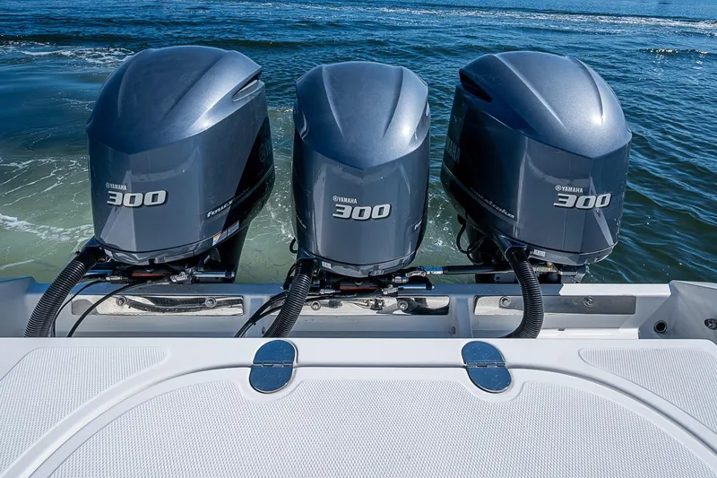 Slide: The Image of Triple Yamaha 300 outboard engines on a 2017 Venture 39 Open boat, cruising on water. - 41