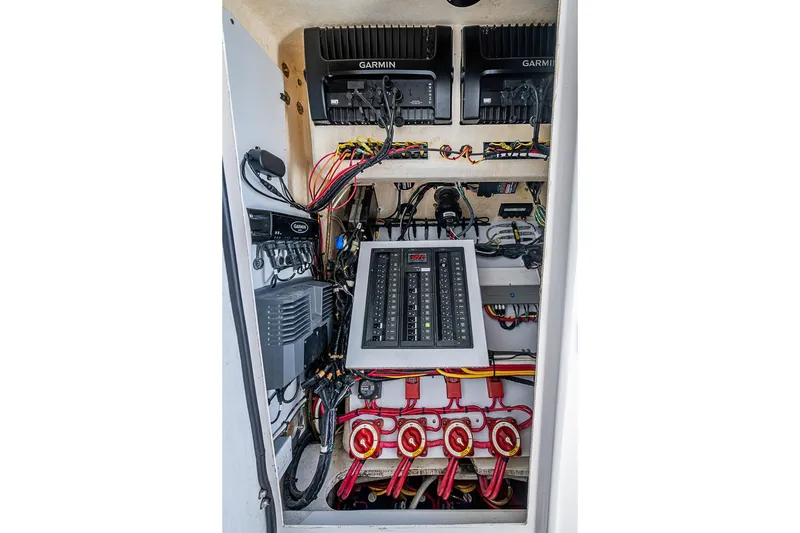 Slide: The Image of Electrical panel and wiring inside a 2017 Venture 39 Open boat, featuring Garmin equipment. - 43