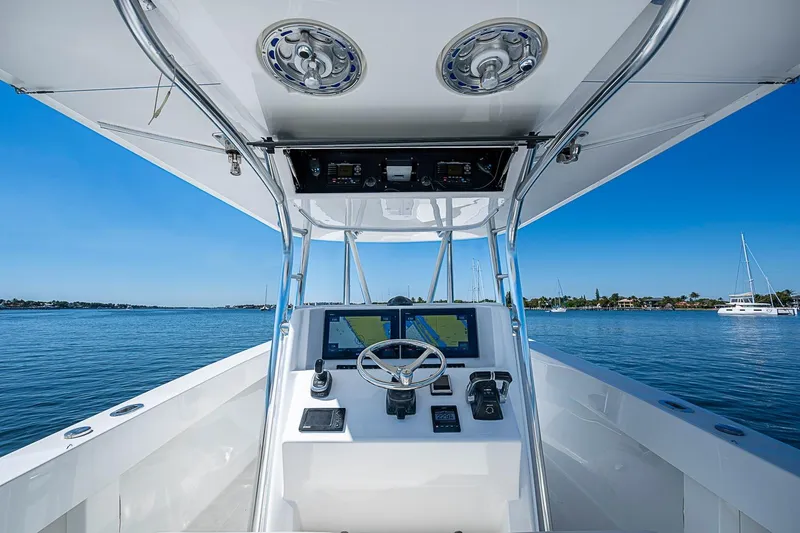 Slide: The Image of 2017 Venture 39 Open boat helm with navigation system on calm water. - 46