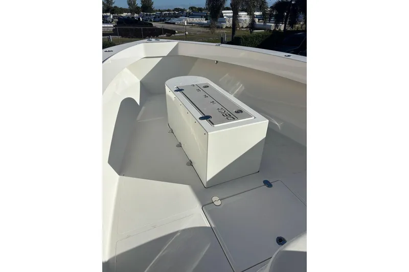Slide: The Image of 2017 Venture 39 Open boat deck with storage compartment, outdoor setting. - 8