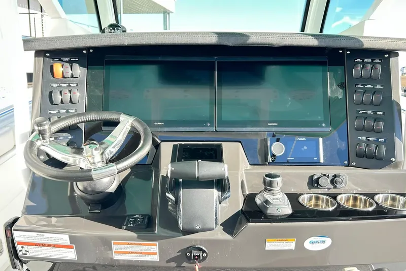 Slide: The Image of 2023 Blackfin 332 CC helm with dual Garmin displays and modern controls. - 11