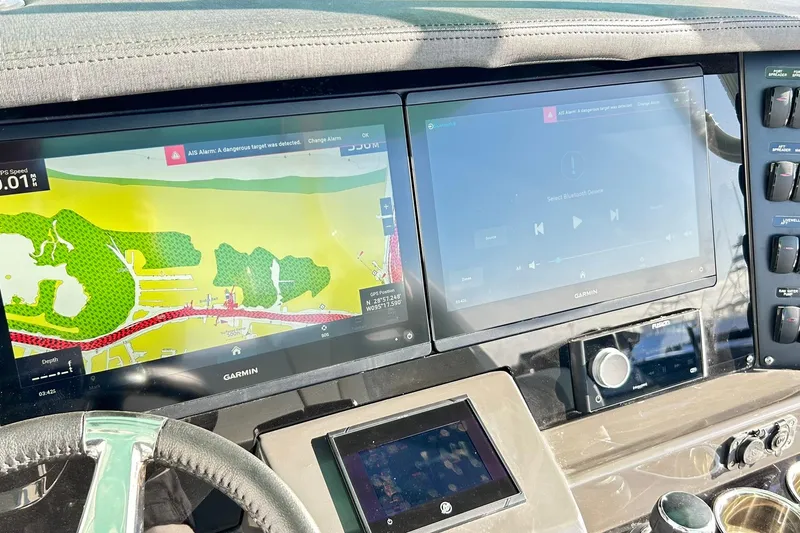 Slide: The Image of 2023 Blackfin 332 CC dashboard with Garmin navigation and control screens. - 12