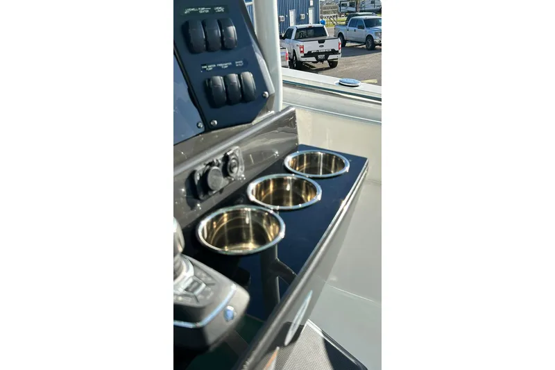 Slide: The Image of 2023 Blackfin 332 CC boat console with stainless steel cup holders and control panel. - 20
