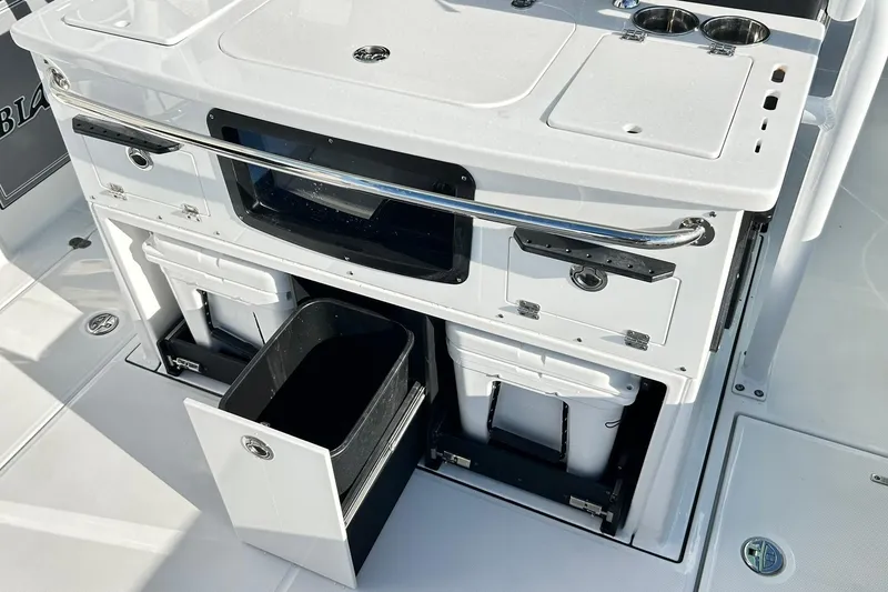Slide: The Image of 2023 Blackfin 332 CC boat interior with storage compartments and utility features. - 25