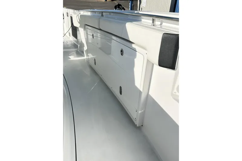 Slide: The Image of 2023 Blackfin 332 CC boat interior with storage compartments and cushioned seating. - 28