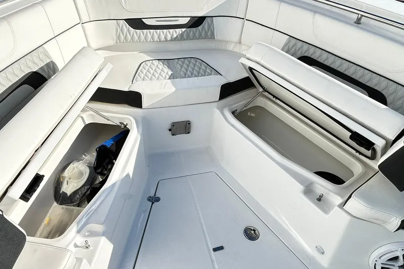 Slide: The Image of 2023 Blackfin 332 CC boat interior with open storage compartments and cushioned seating. - 35