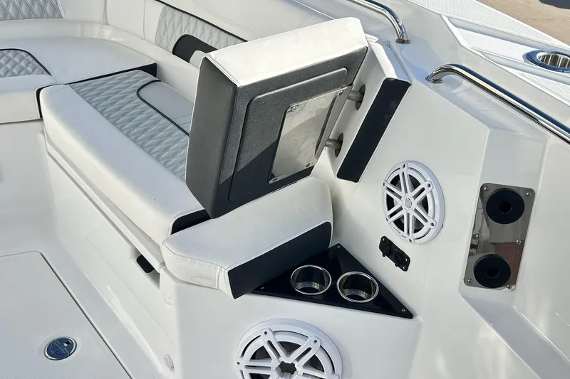 Slide: The Image of 2023 Blackfin 332 CC boat interior with cushioned seating and built-in speakers. - 42