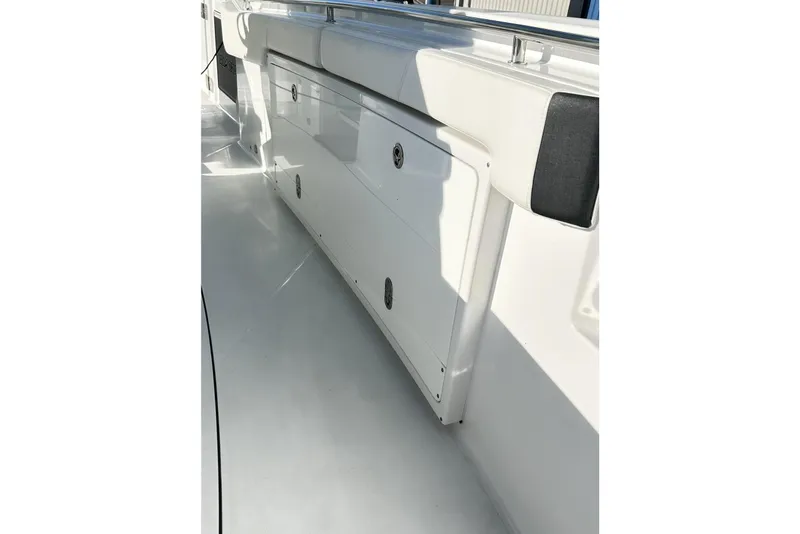 Slide: The Image of 2023 Blackfin 332 CC boat interior with storage compartments and seating. - 46