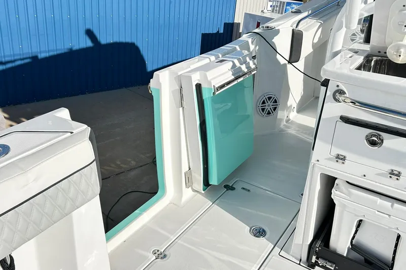 Slide: The Image of 2023 Blackfin 332 CC boat interior with open door and storage compartments. - 51