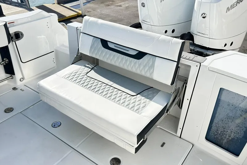 Slide: The Image of 2023 Blackfin 332 CC boat with white cushioned seating and dual Mercury engines. - 53