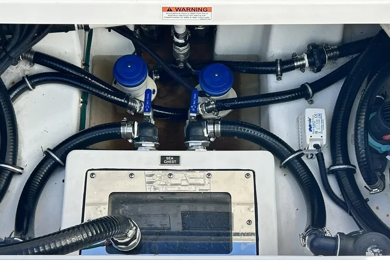 Slide: The Image of 2023 Blackfin 332 CC engine compartment with hoses and sea chest system. - 55