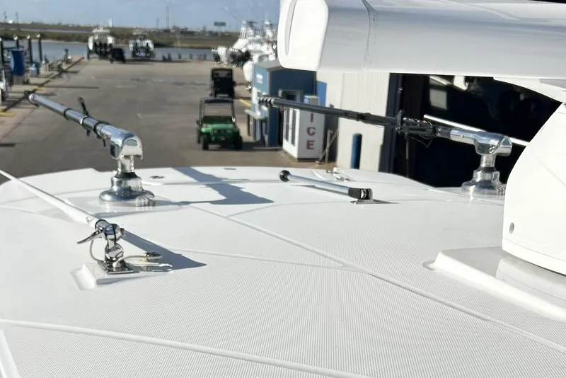 Slide: The Image of 2023 Blackfin 332 CC boat deck with fishing rod holders at marina. - 57