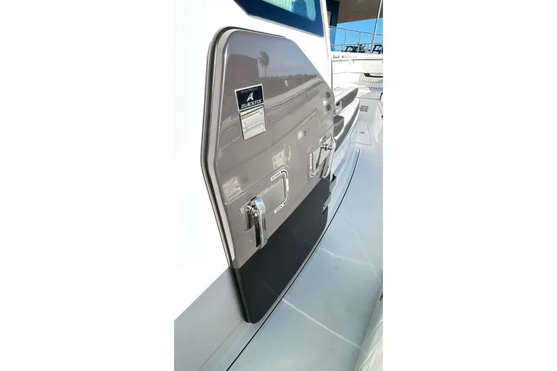 Slide: The Image of 2023 Blackfin 332 CC boat side view with sleek design and chrome details. - 61