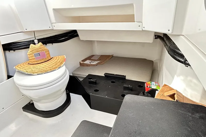 Slide: The Image of 2023 Blackfin 332 CC cabin interior with toilet, hat, and storage space. - 65