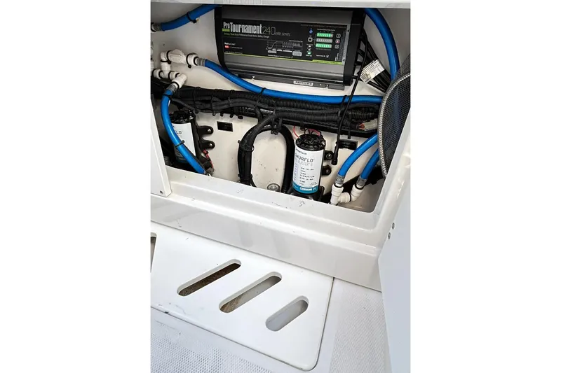Slide: The Image of 2023 Blackfin 332 CC boat wiring and control panel with blue hoses. - 69