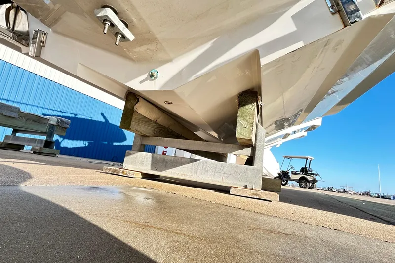 Slide: The Image of 2023 Blackfin 332 CC boat hull on dry dock, blue building background. - 76