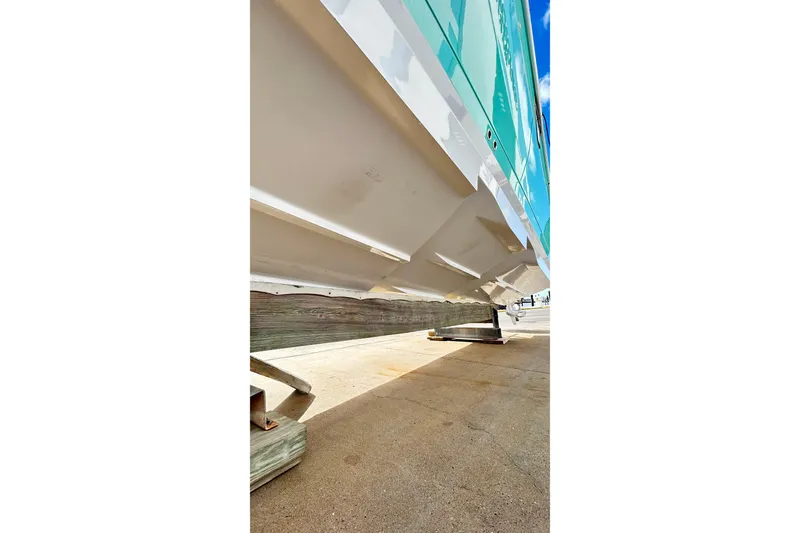 Slide: The Image of 2023 Blackfin 332 CC boat hull on dry dock, showcasing sleek design. - 77
