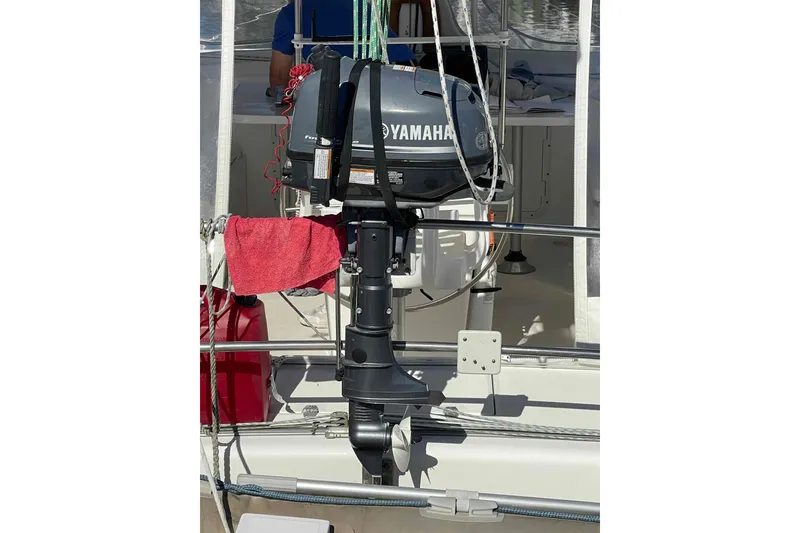 Slide: The Image of Yamaha outboard motor on 1998 Maine Cat Catamaran, with red towel and railing. - 16
