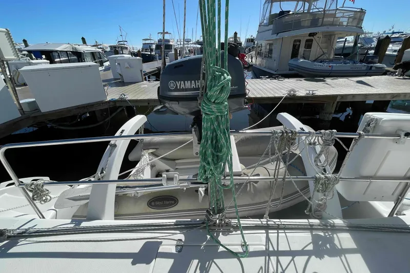 Slide: The Image of Outboard motor on a 1998 Maine Cat Catamaran docked at a marina. - 26