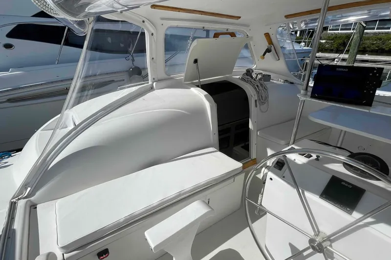 Slide: The Image of 1998 Maine Cat Catamaran cockpit with steering wheel and navigation equipment. - 28