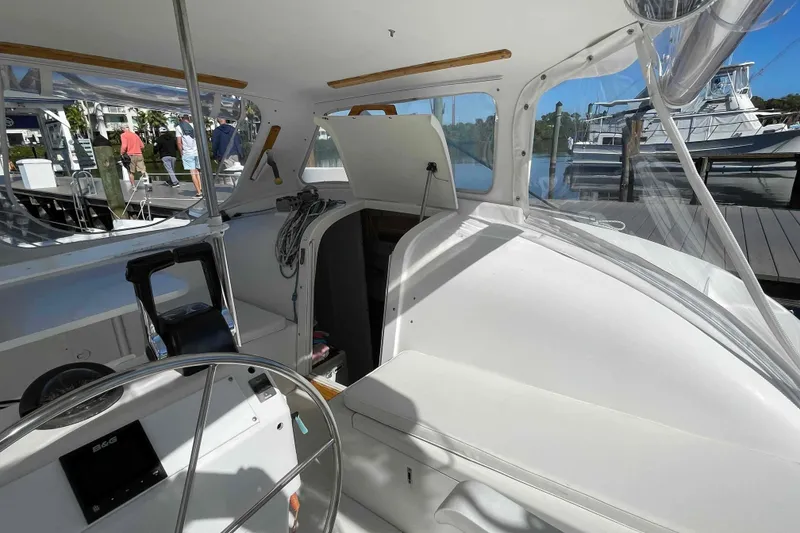 Slide: The Image of 1998 Maine Cat Catamaran cockpit with steering wheel and navigation equipment. - 29