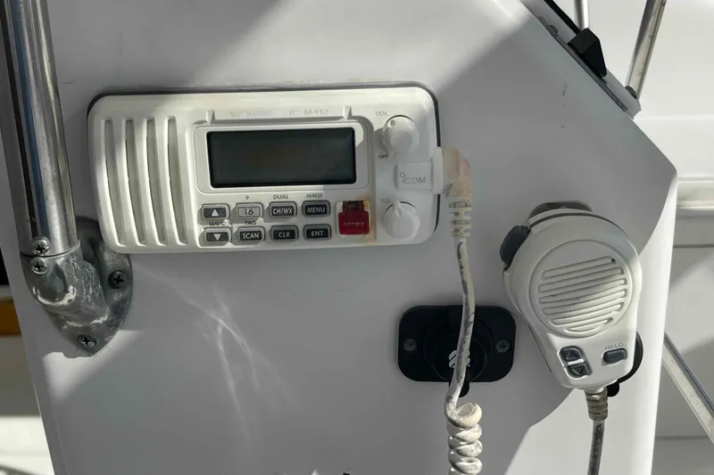 Slide: The Image of 1998 Maine Cat Catamaran cockpit with navigation equipment and marina view. - 36