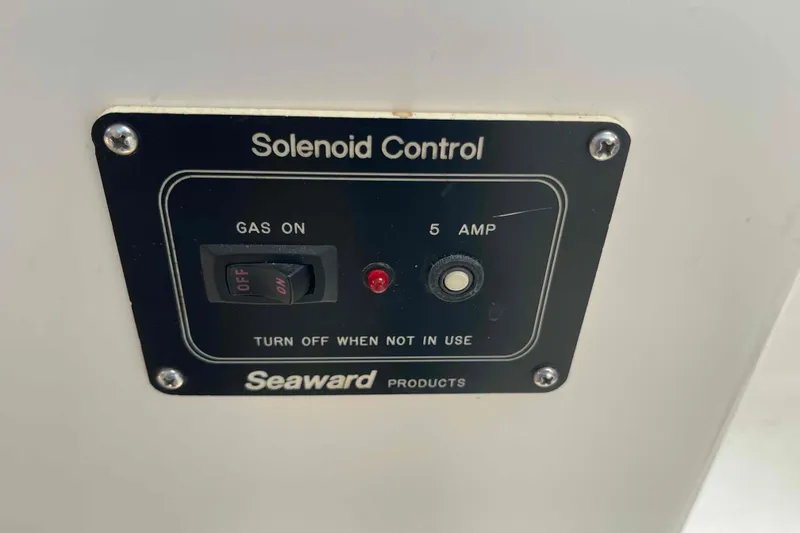 Slide: The Image of Two-burner stove on a 1998 Maine Cat Catamaran, featuring control knobs and metal grates. - 38