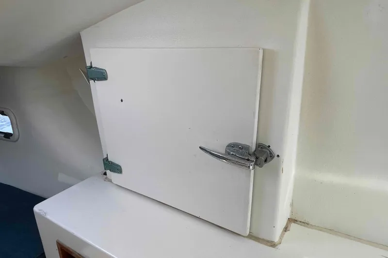 Slide: The Image of 1998 Maine Cat Catamaran cabin interior with bed, window, and storage shelf. - 40