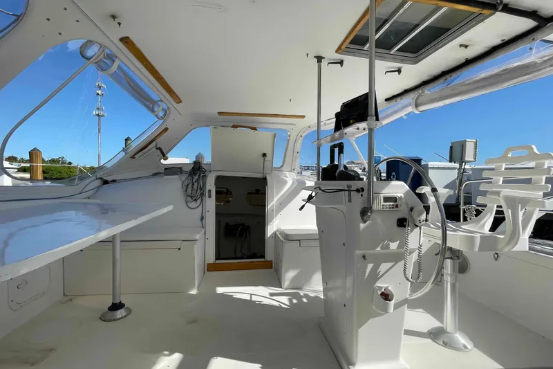 Slide: The Image of Open storage compartment inside a 1998 Maine Cat Catamaran, showing interior space and latch. - 42