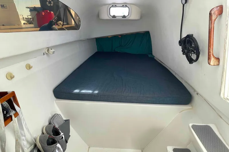 Slide: The Image of 1998 Maine Cat Catamaran interior with storage and sleeping area. - 45