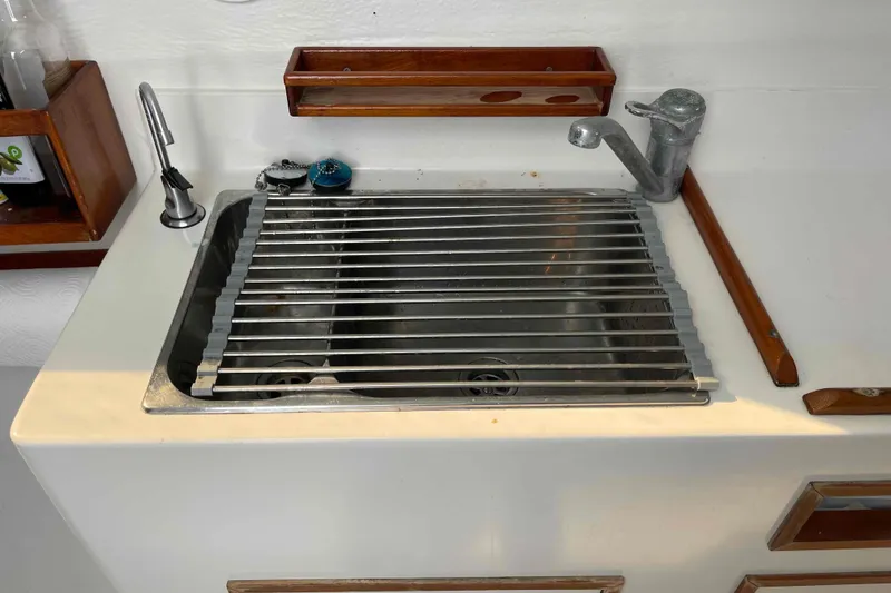 Slide: The Image of Cozy cabin interior of a 1998 Maine Cat Catamaran with a bed and storage space. - 46