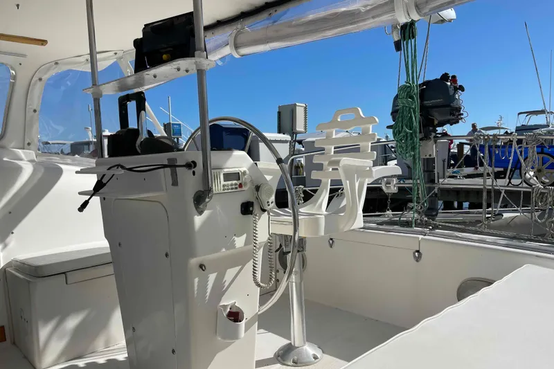Slide: The Image of 1998 Maine Cat Catamaran kitchen sink with wooden shelves and cleaning supplies. - 48