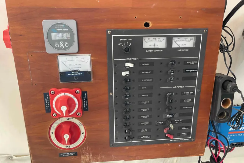 Slide: The Image of Control panel and navigation charts inside a 1998 Maine Cat Catamaran. - 51