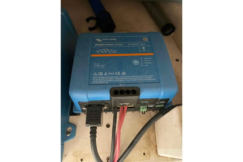 Slide: The Image of Electrical system components inside a 1998 Maine Cat Catamaran, featuring inverters and wiring. - 53