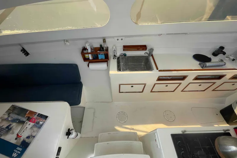 Slide: The Image of 1998 Maine Cat Catamaran cockpit with open hatch and coiled ropes. - 59