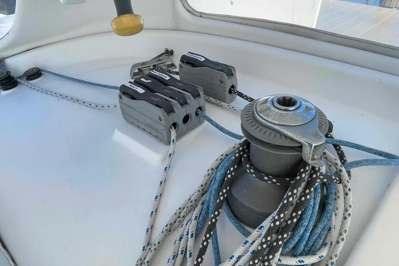 Slide: The Image of Interior view of a 1998 Maine Cat Catamaran, featuring seating and nautical equipment. - 62