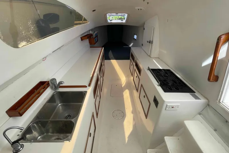 Slide: The Image of Interior of 1998 Maine Cat Catamaran with kitchen, sink, and stove. - 7