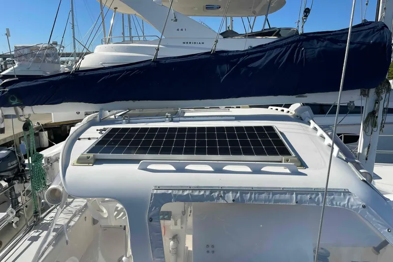 Slide: The Image of 1998 Maine Cat Catamaran with solar panel on deck, docked at marina. - 9