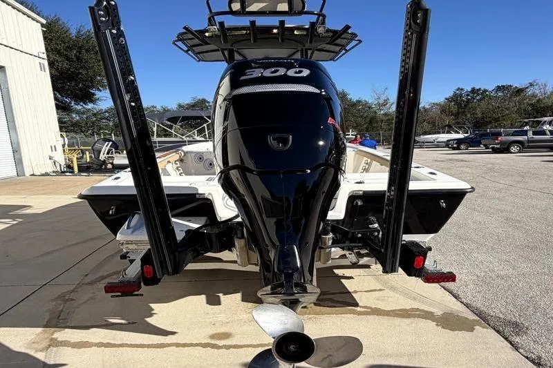 Slide: The Image of 2016 Key West 230 Bay Reef boat with powerful 300 HP engine, parked outdoors. - 10